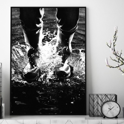 Poster SplashingEn kontrastrik svartvit poster över ett par fötter i gummistövlar.Tryckt på miljövänligt 230g, matt papperFinns i flera storlekar Postern levereras utan ram